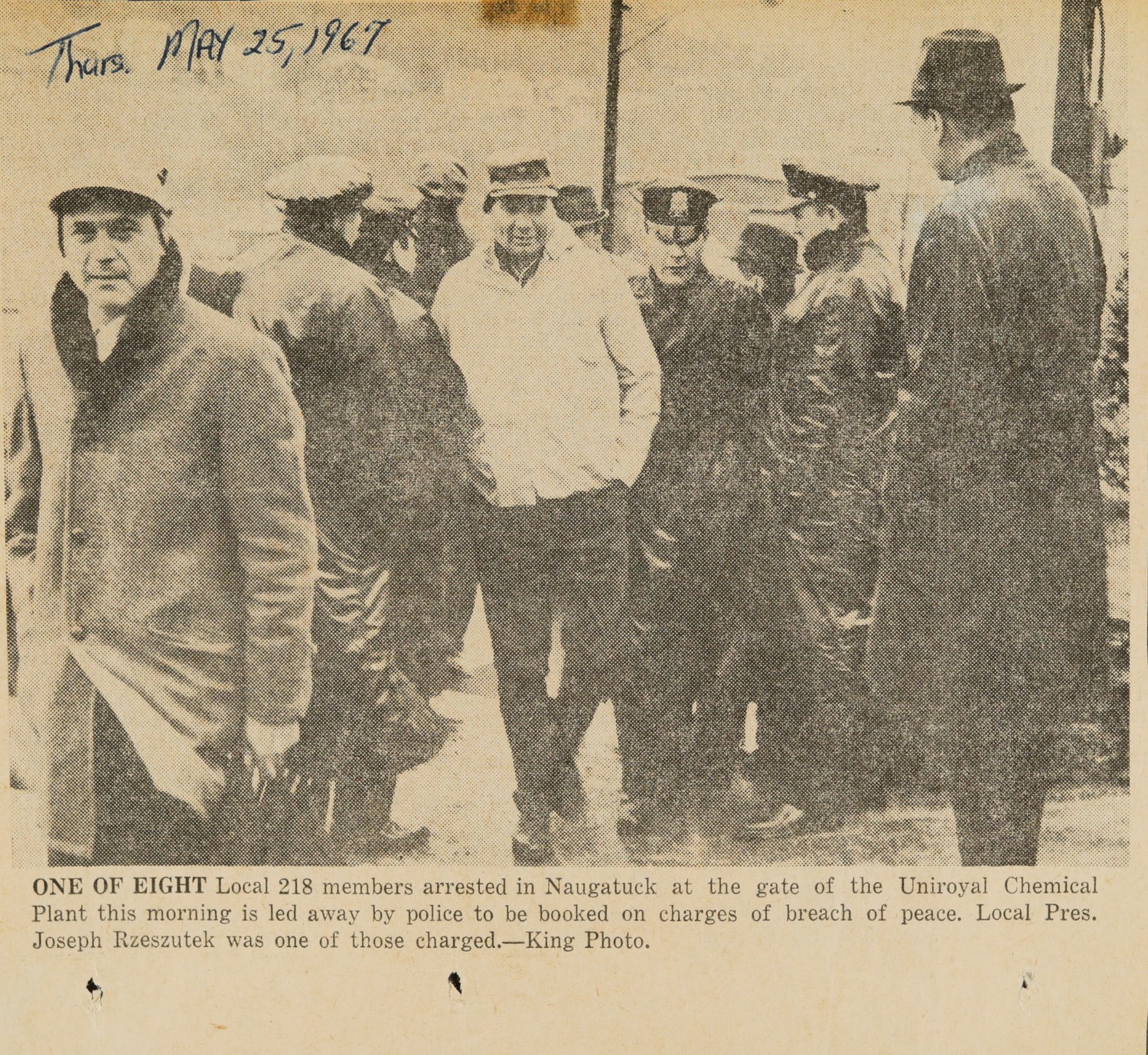 ONE OF EIGHT Local 218 members arrested in Naugatuck at the gate of the Uniroyal Chemical Plant this morning is led away by police to be booked on charges of breach of peace. Local Pres. Joseph Rzeszutek was one of those charged.