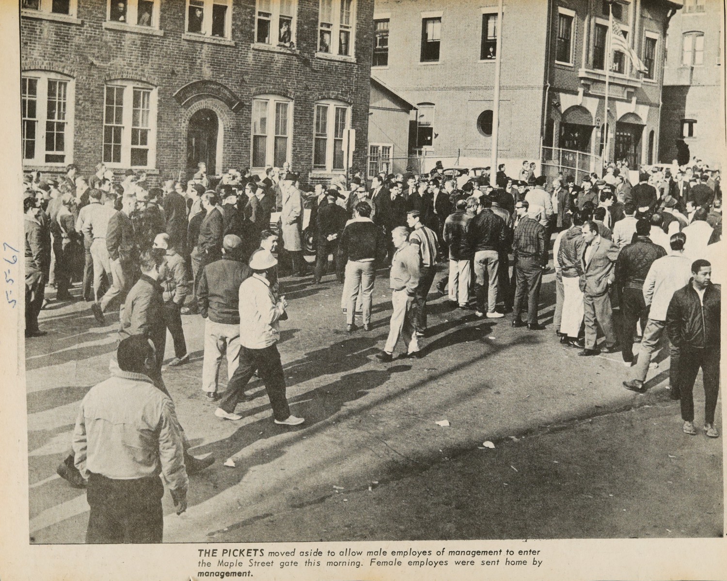 THE PICKETS moved aside to allow male employes of management to enter the Maple Street gate this morning. Female employes were sent home by management.