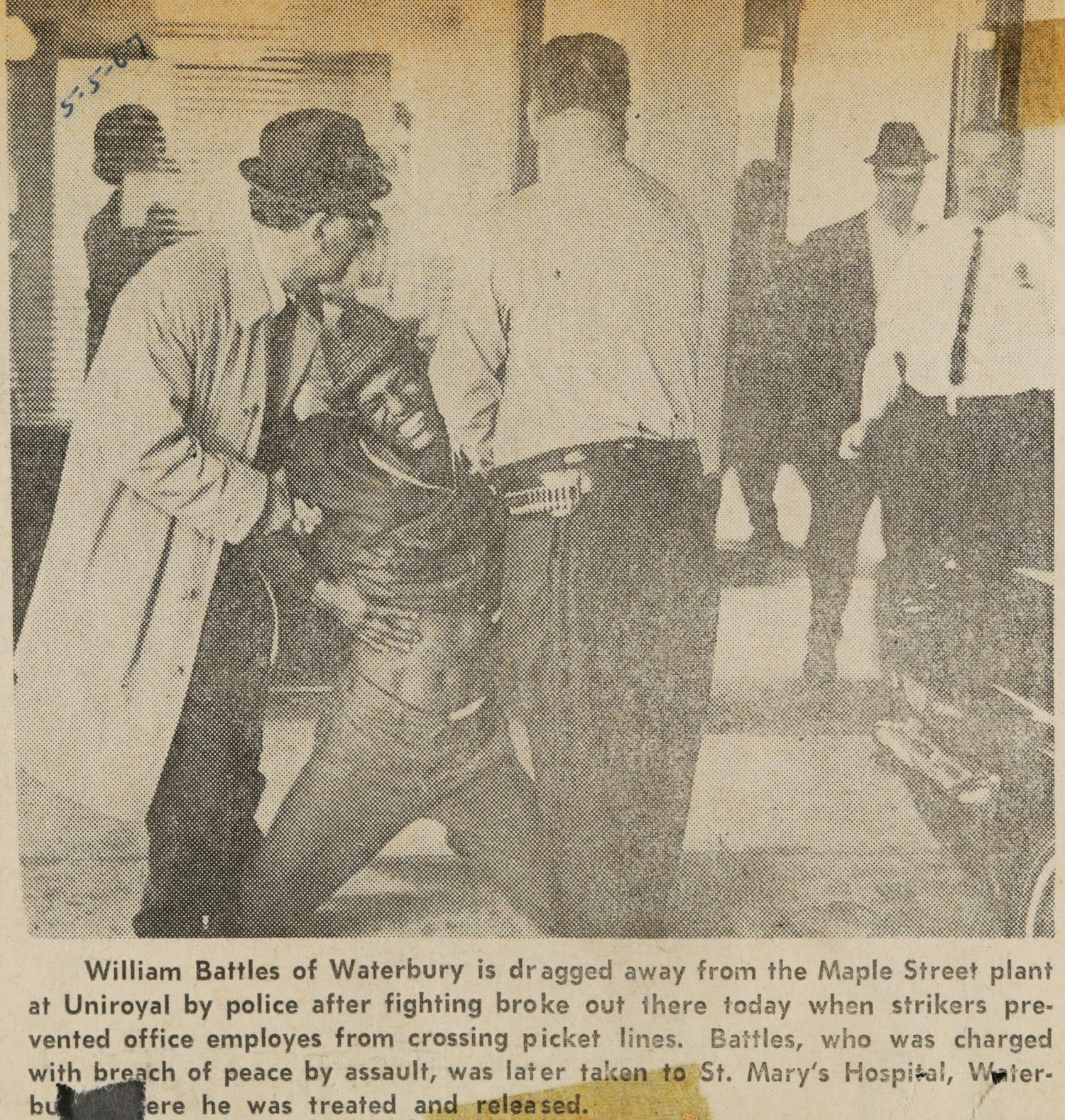 William Battles of Waterbury is dragged away from the Maple Street plant at Uniroyal by police after fighting broke out there today when strikers prevented office employes from crossing picket lines.