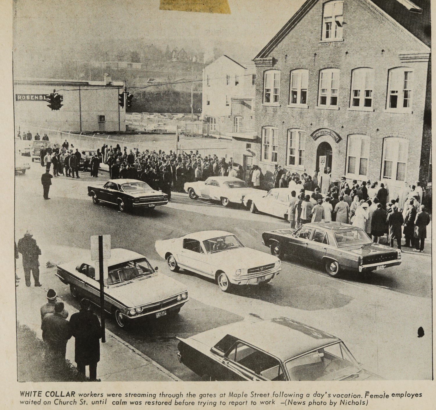 WHITE COLLAR workers were streaming through the gates at Maple Street following a day's vacation. Female employes waited on Church St. until calm was restored before trying to report to work