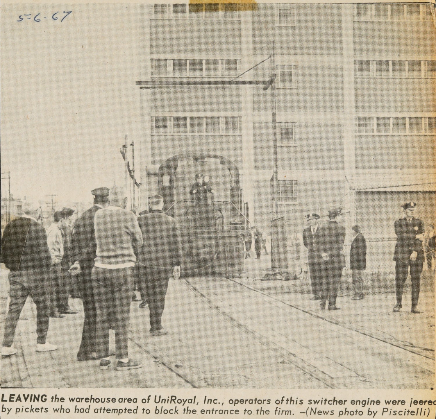 Leaving the warehouse area of UniRoyal, Inc., operators of this switcher engine were jeered by pickets who had attempted to block entrance to the firm.