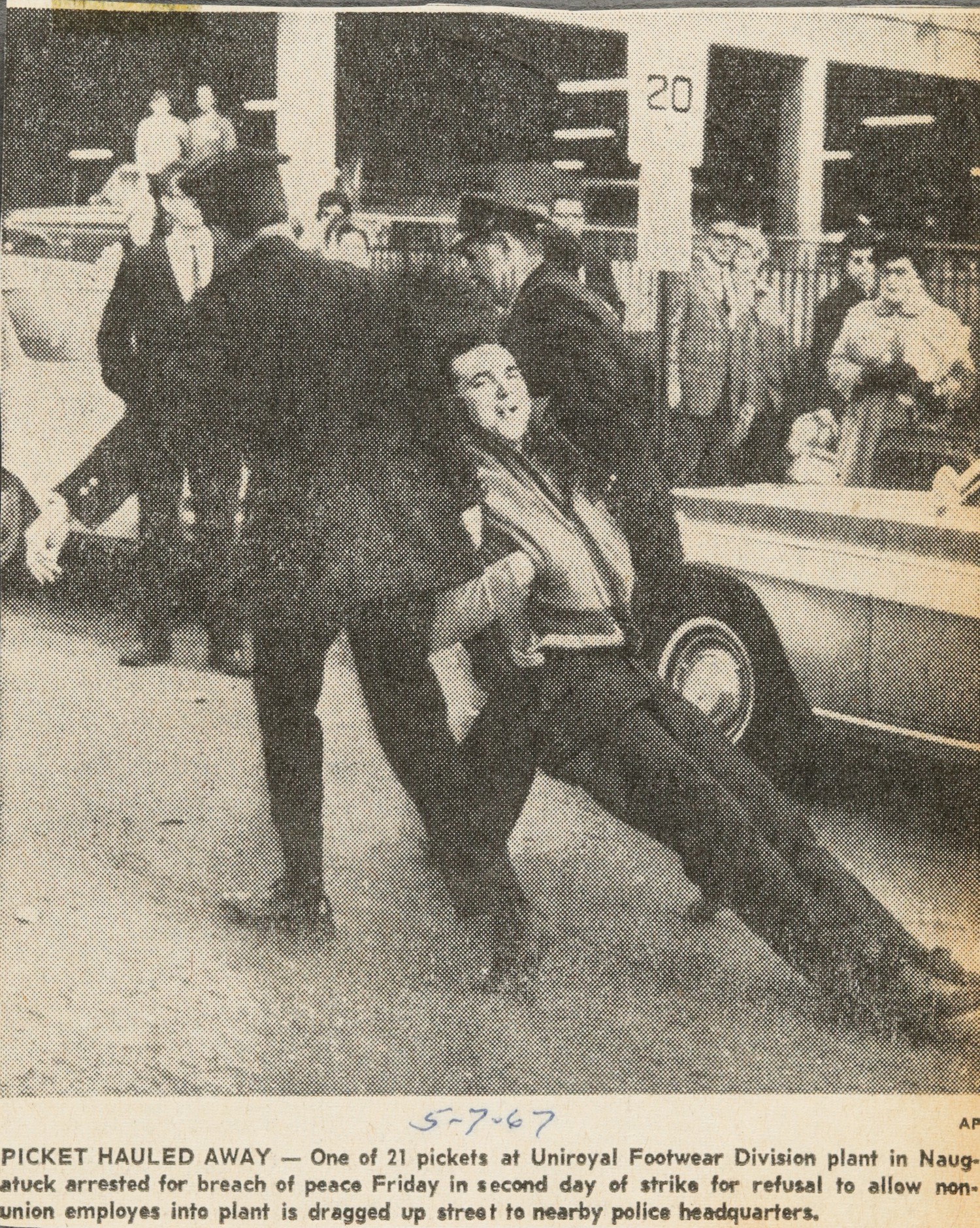 PICKET HAULED AWAY — One of 21 pickets at Uniroyal Footwear Division plant in Naugatuck arrested for breach of peace Friday in second day of strike for refusal to allow non-union employes into plant is dragged up street to nearby police headquarters.